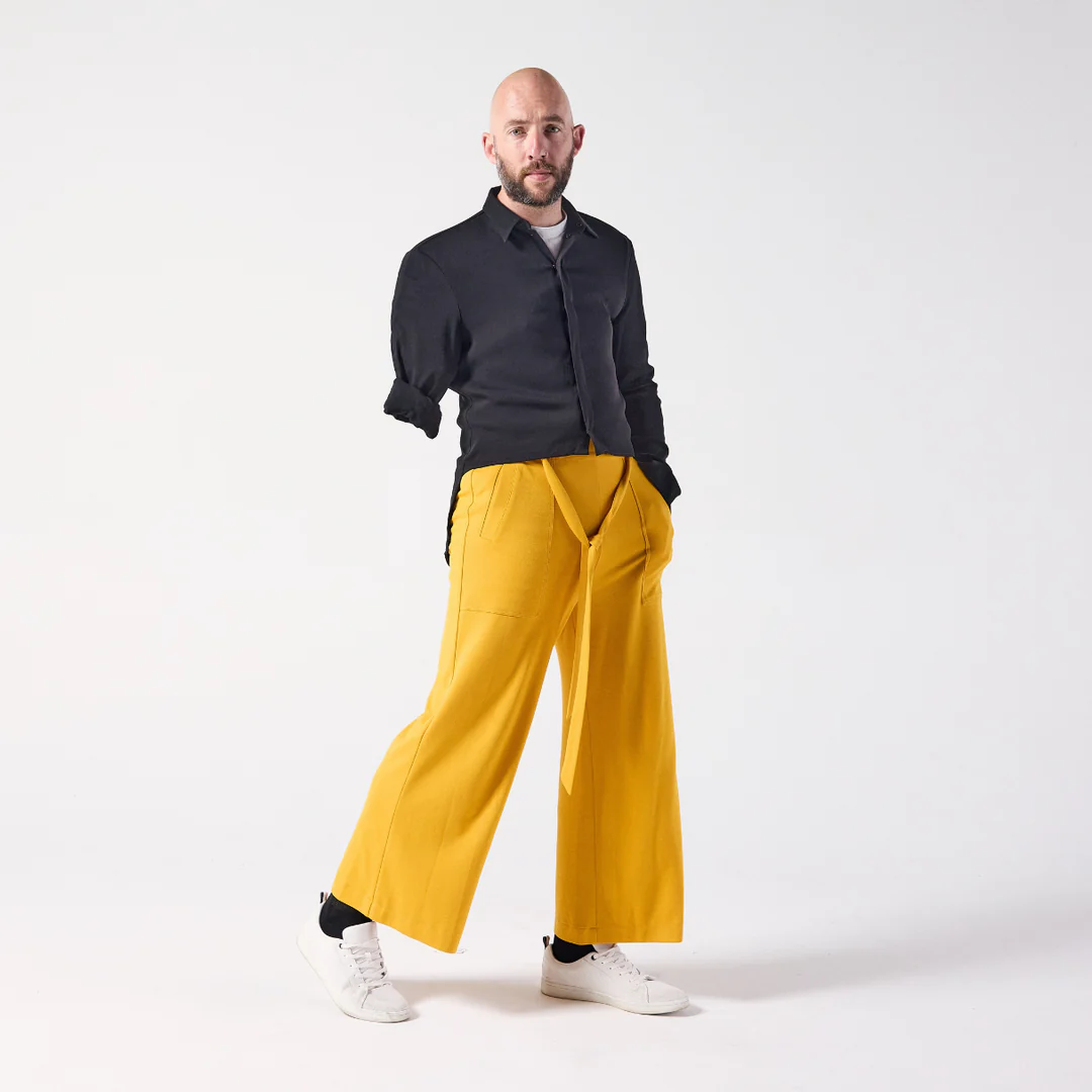 Yellow loose trousers with a lower leg pocket for wheelchair users